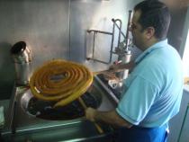 The churrero proudly displays the churro coil fresh from the deep frier
